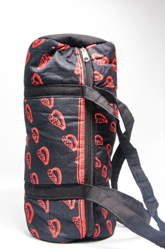 Black and orange ankara shoulder drum bag.