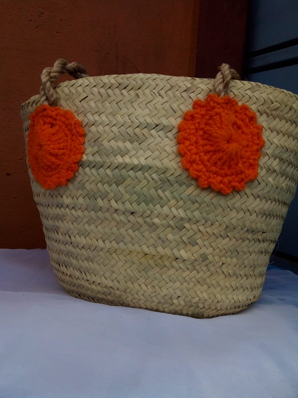 Orange flowered straw basket